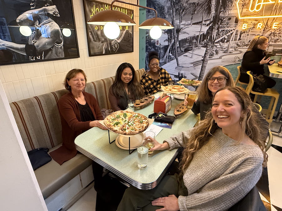 Ahimsa Kids Set Teachers enjoying a pizza together.