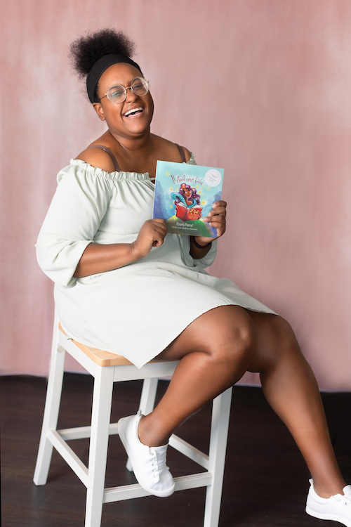 On-set teacher Pamela Pascal holding her children's book, Il était une fois.