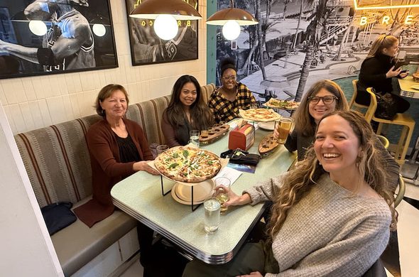 Ahimsa Kids Set Teachers enjoying a pizza together.