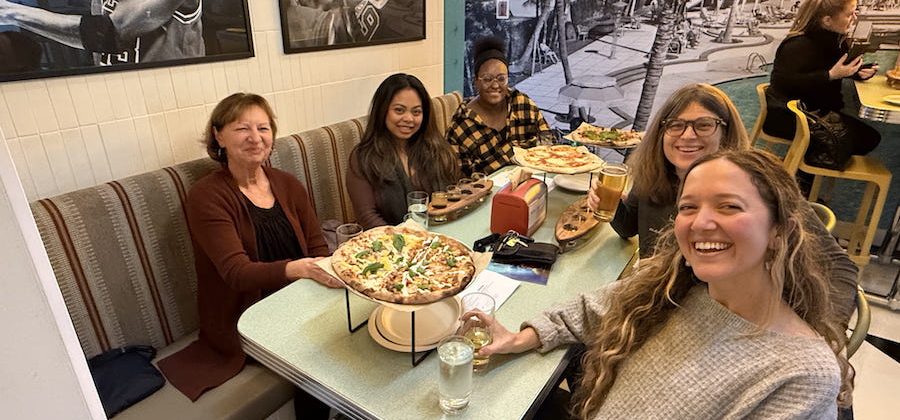 Ahimsa Kids Set Teachers enjoying a pizza together.